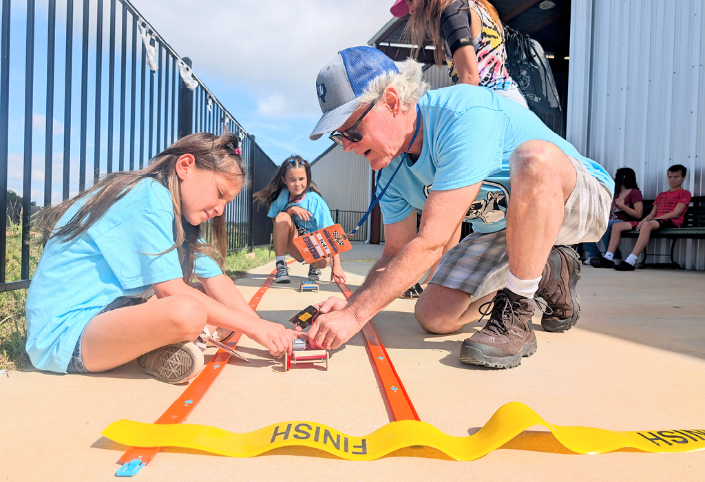 Kids testing their solar cars on the test track.