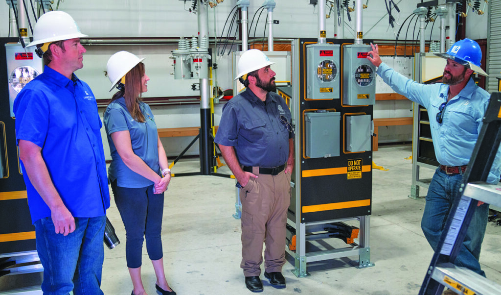 Local officials in PEC's training center learning about equipment used by PEC