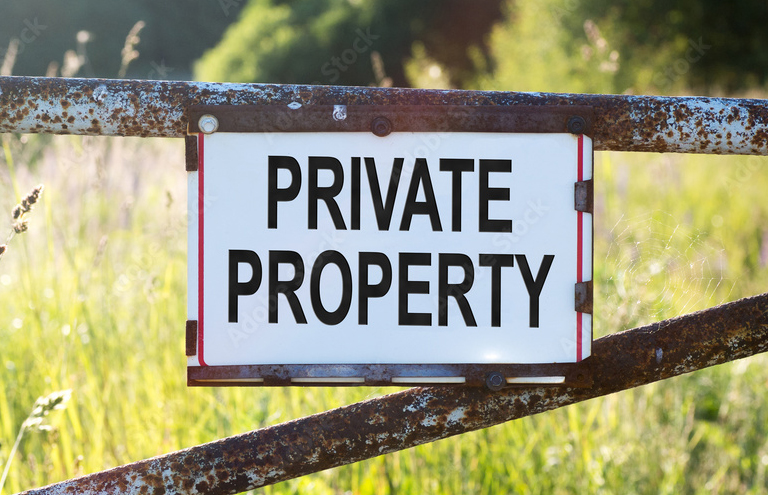 Photo of a private property sign on fence