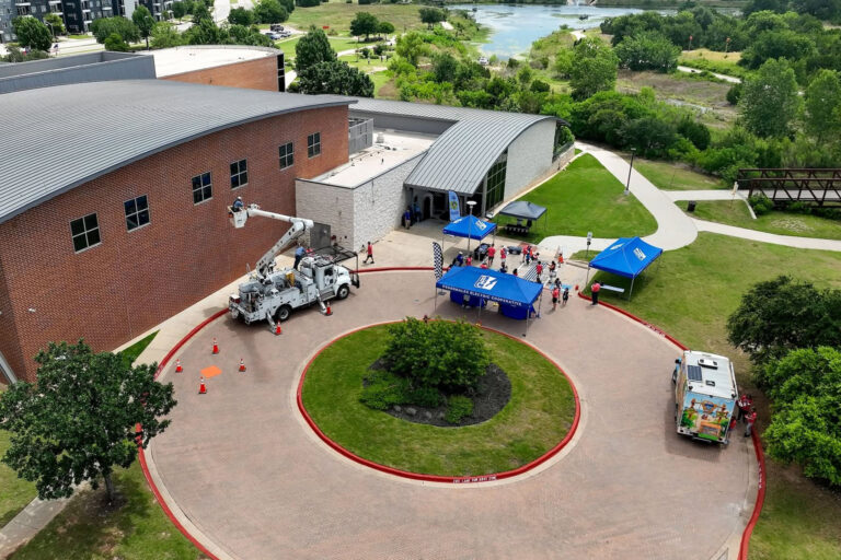 Drone photo of PEC bucket trucks outside the solar derby