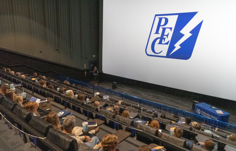 Photo of PEC scholarship recipients sitting in auditorium watching PEC presentation.