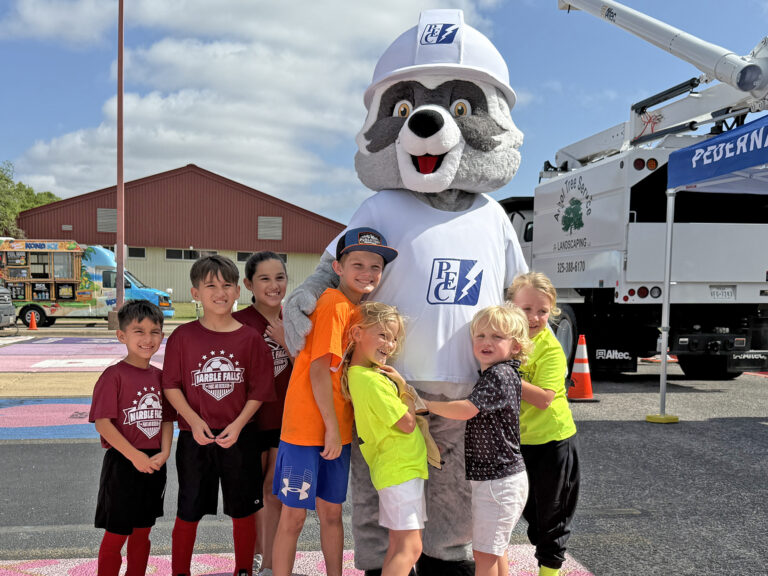 Photo of PEC's Wattson Raccoon and member's children